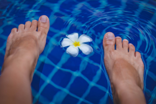 Feet in water with flower